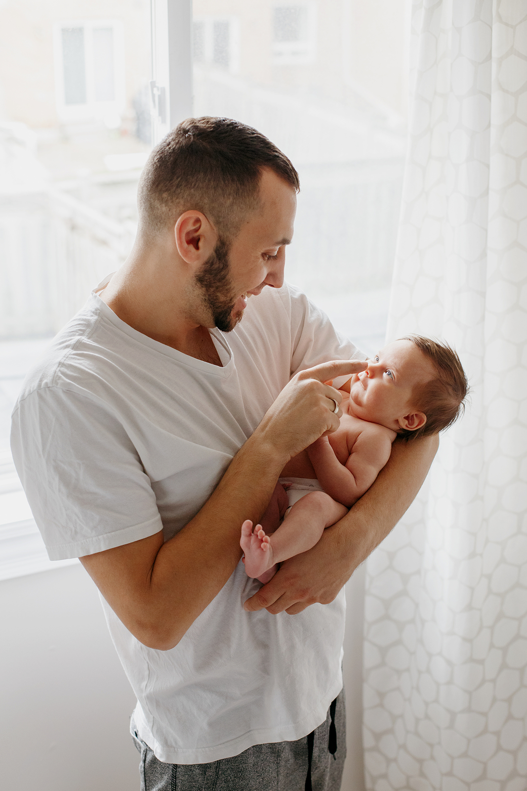 Happy Caucasian Father Holding Newborn Baby. Male Man Parent Roc